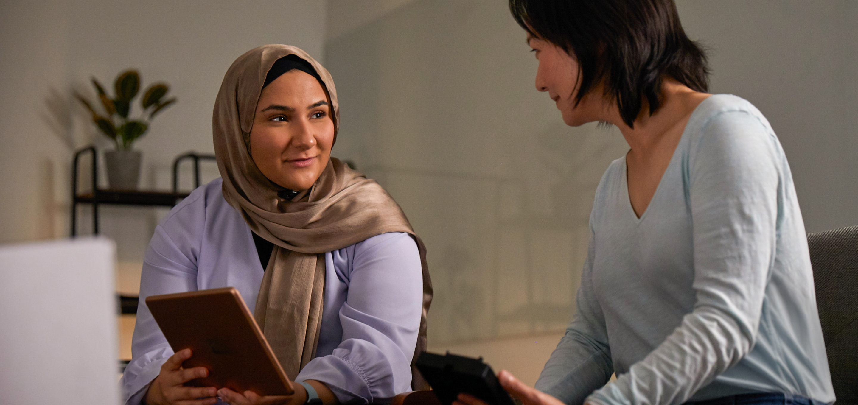 A group of Apple machine learning and AI employees have a conversation in an office.