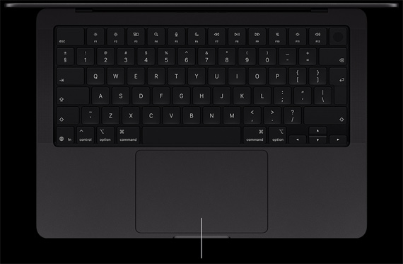 MacBook Pro with PROLED XDR Display, space black color, open, showing keyboard and Force Touch trackpad