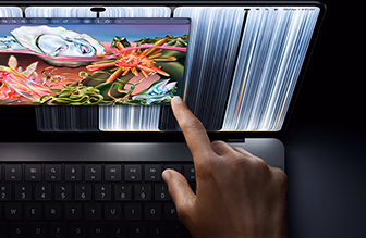 MacBook Pro with PROLED XDR Display, space black color, user resizes a window on screen with their fingertip