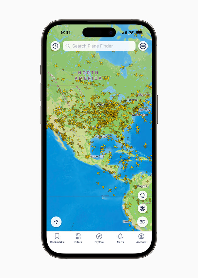 A map screen within the Plane Finder app on iPhone 14 Plus shows planes flying across North America.