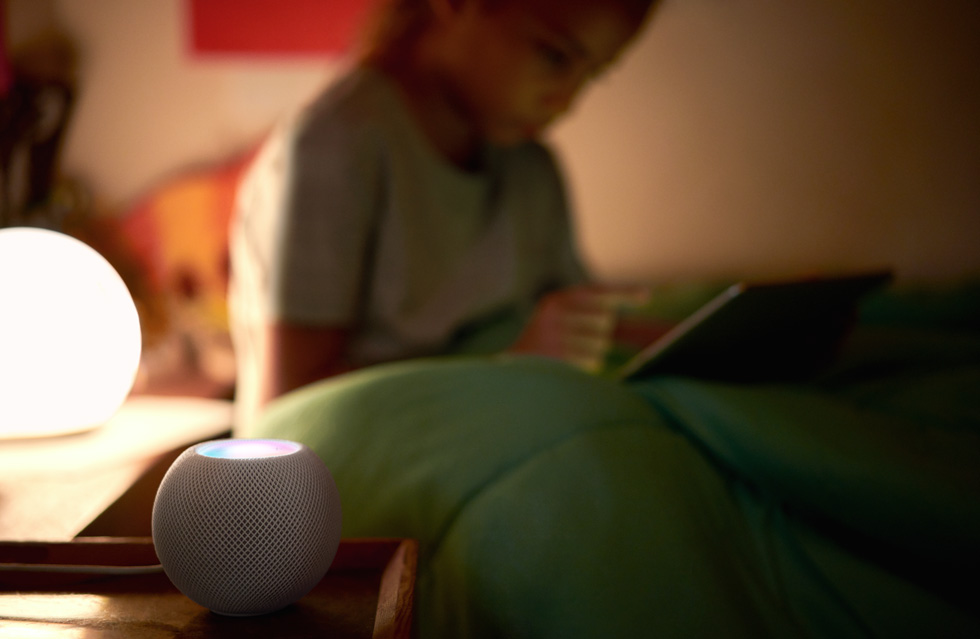 A child bedside making use of HomePod mini’s smart home controls.