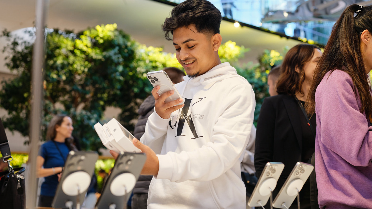 A customer documents their purchases at Apple Fifth Avenue in New York City.