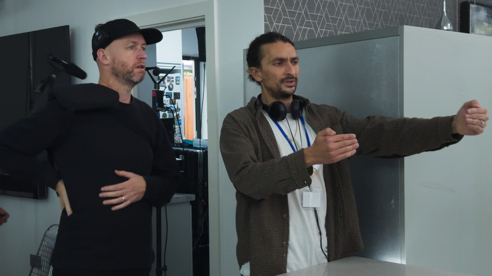 Director Aneil Karia and cinematographer Stuart Bentley on set with crew.