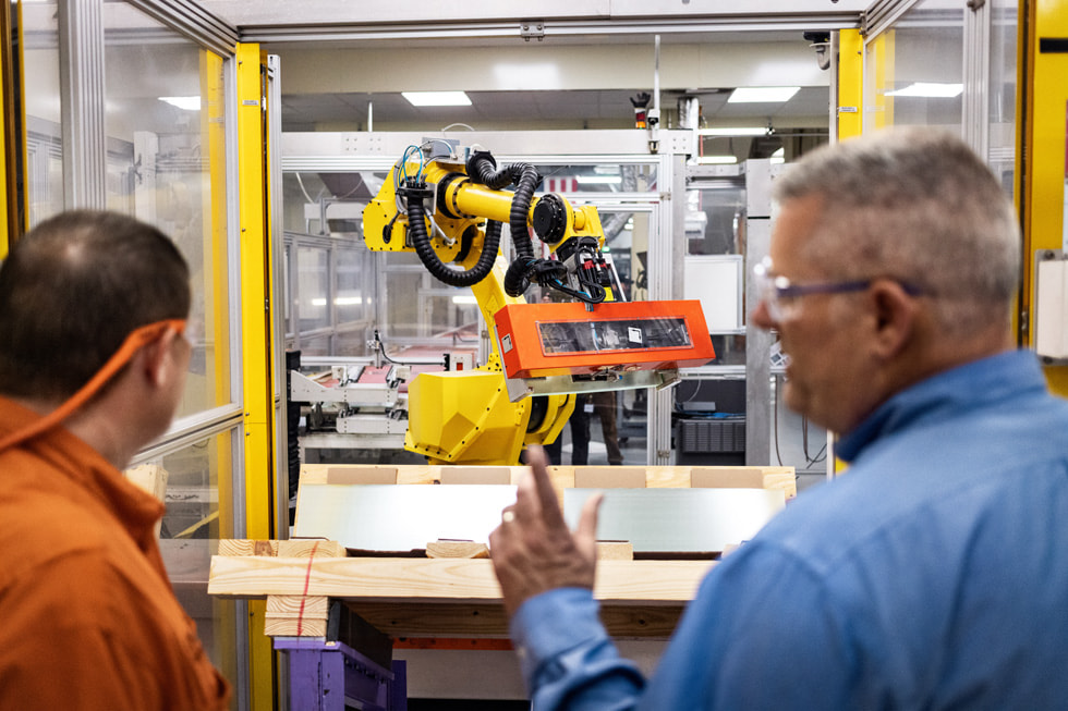 Dos trabajadores observan a través de una ventana dentro de la planta de Corning en Harrodsburg, Kentucky.