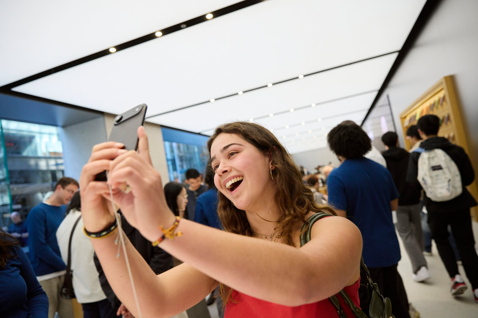 A happy customer takes a selfie using iPhone Air inside Apple Sydney in Australia.