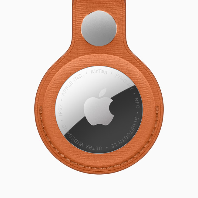 The new AirTag with the FineWoven Key Ring in fox orange.