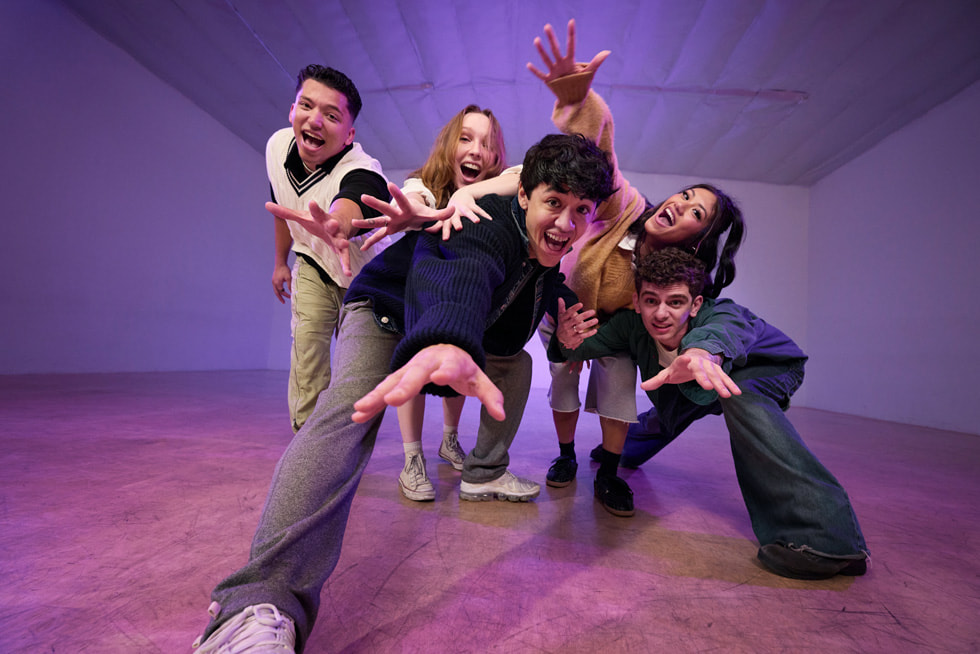 Kyle Hanagami and four dancers pose with their hands reaching toward the camera in a studio setting.