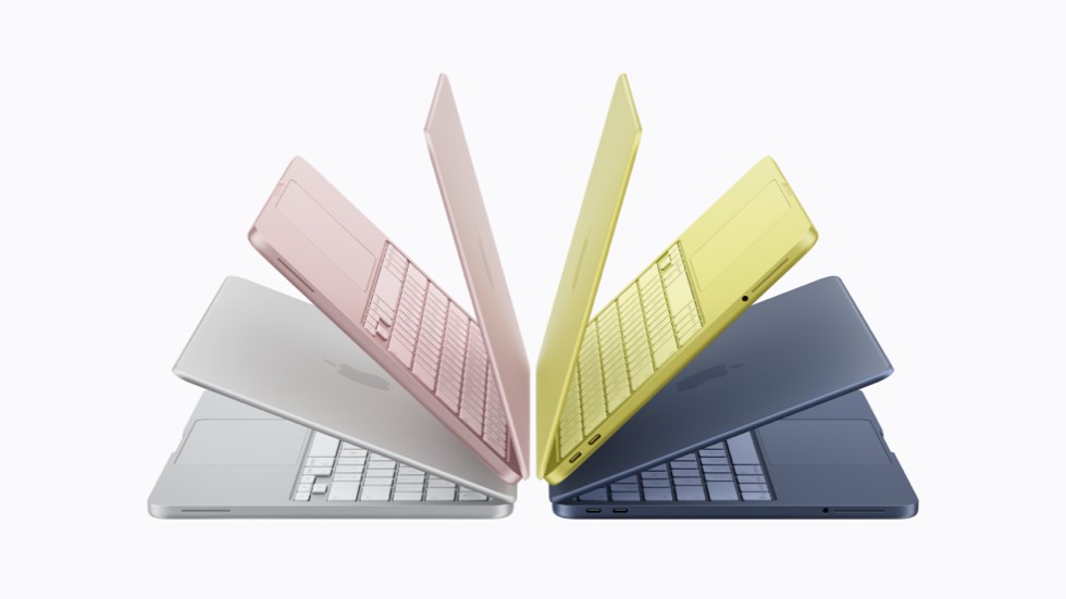 Four MacBook Neo devices in silver, blush, citrus, and indigo.