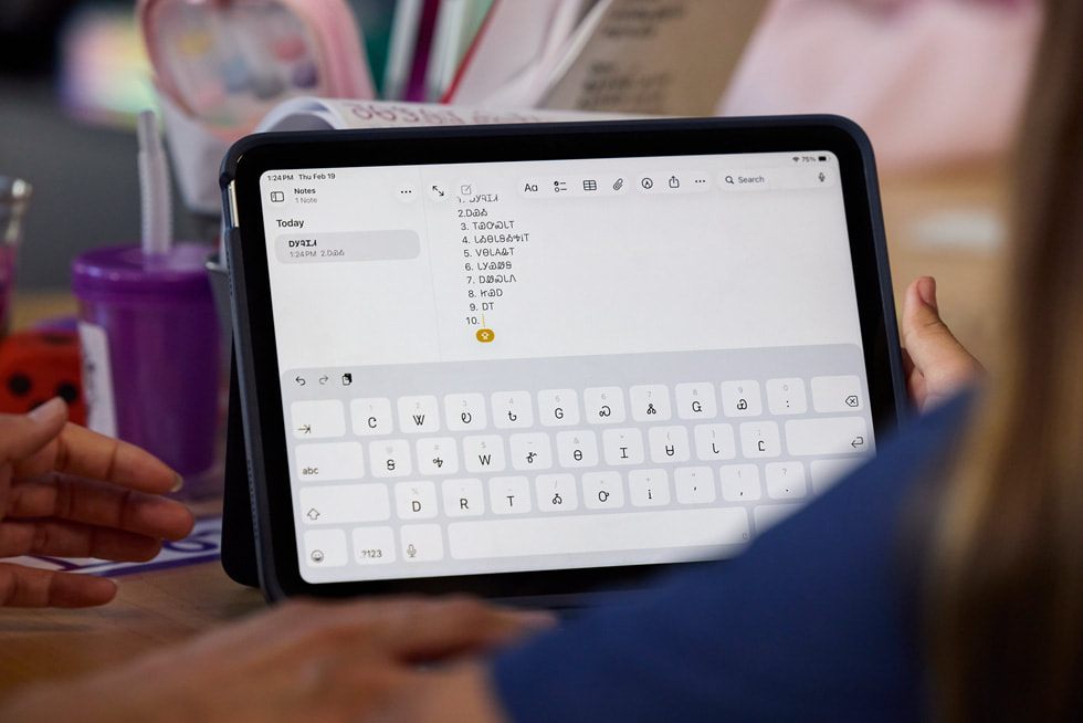 A closeup of an iPad screen shows the Cherokee language typed in Notes.