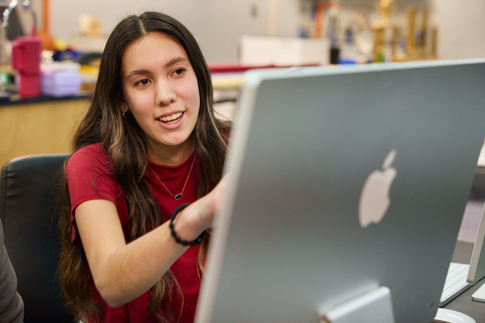 Melissa Fourkiller is pictured sitting at a classroom iMac.