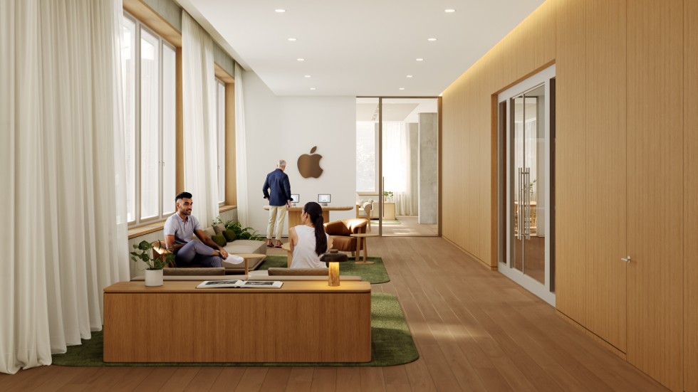 Drei Personen sitzen auf einer langen Holzbank in einem minimalistisch gestalteten Empfangsbereich mit hellen Holzwänden und einem grünen Teppich.
