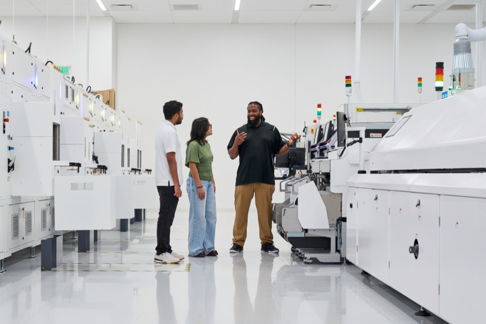 Three people are pictured on the factory floor at Apple’s Advanced Manufacturing Center in Houston.