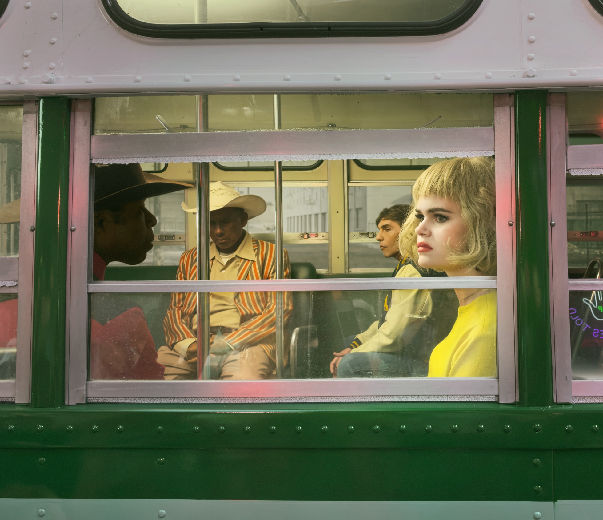 A photo shows people sitting on a train.