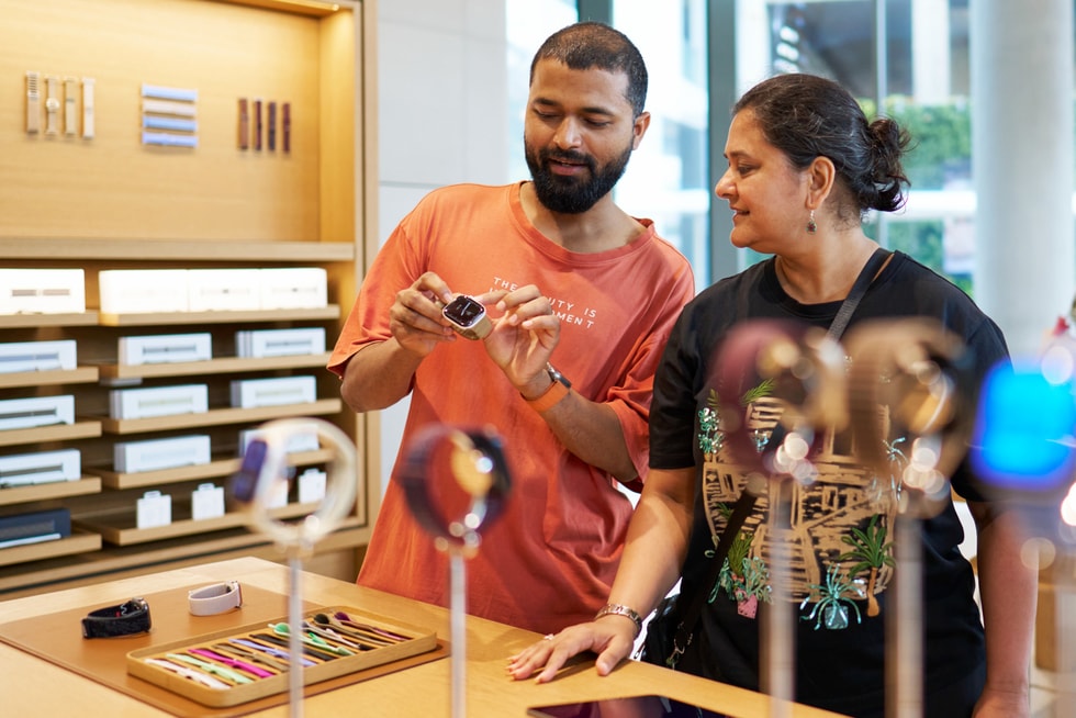 Two customers look at Apple Watch Series 12 at Apple BKC.