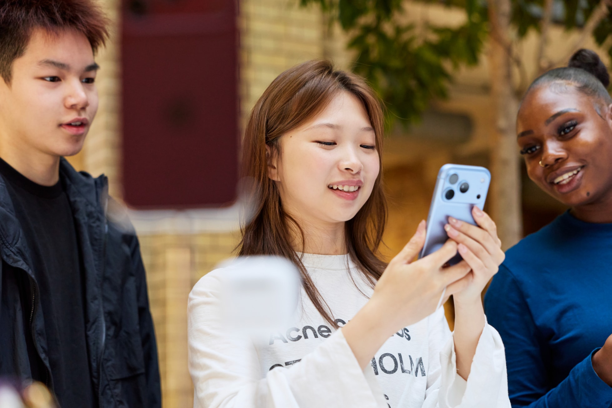 A customer tries out a glacier iPhone 18 Pro at Apple Covent Garden.