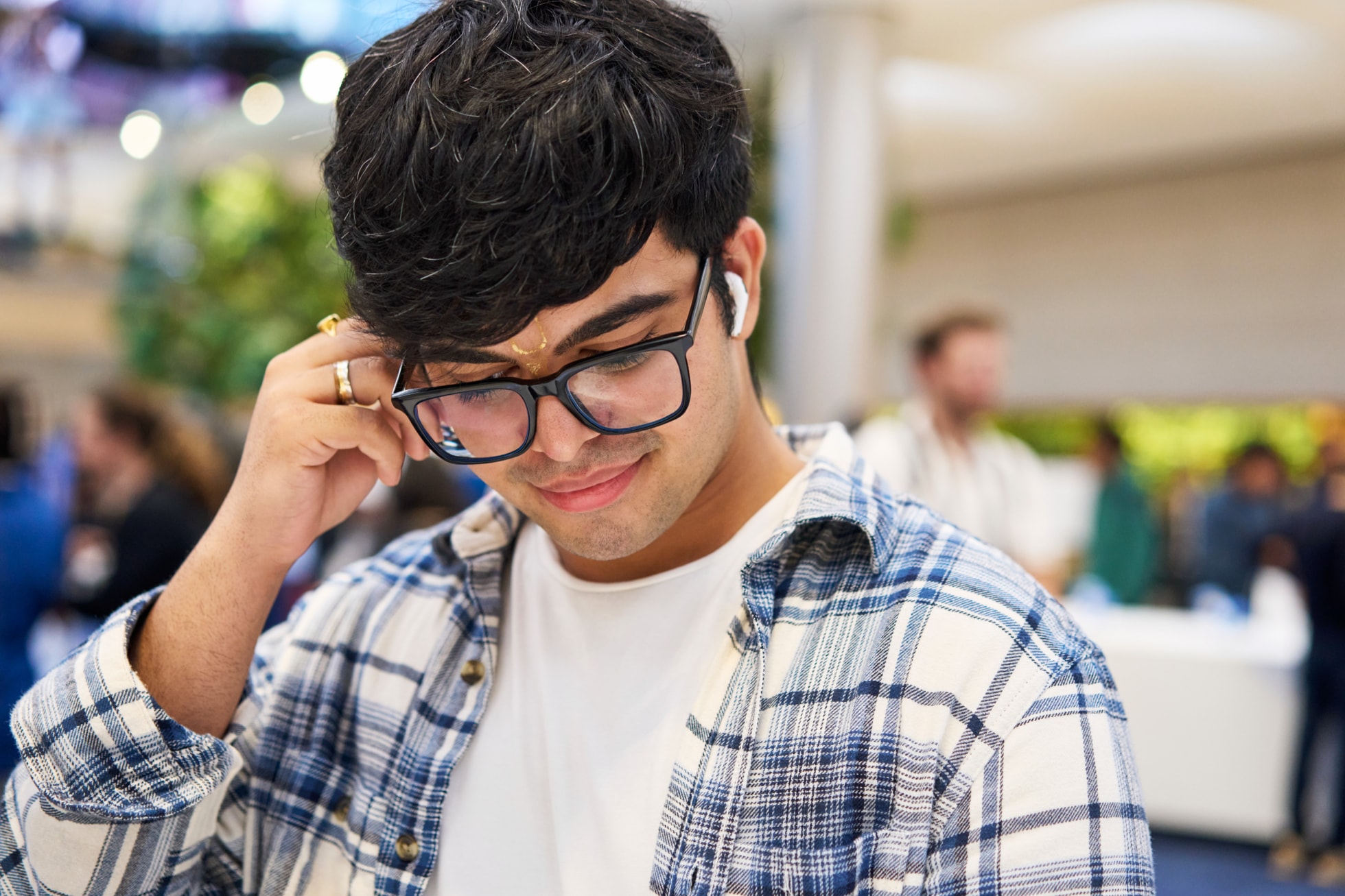 A customer tries on AirPods 5 at Apple Fifth Avenue.