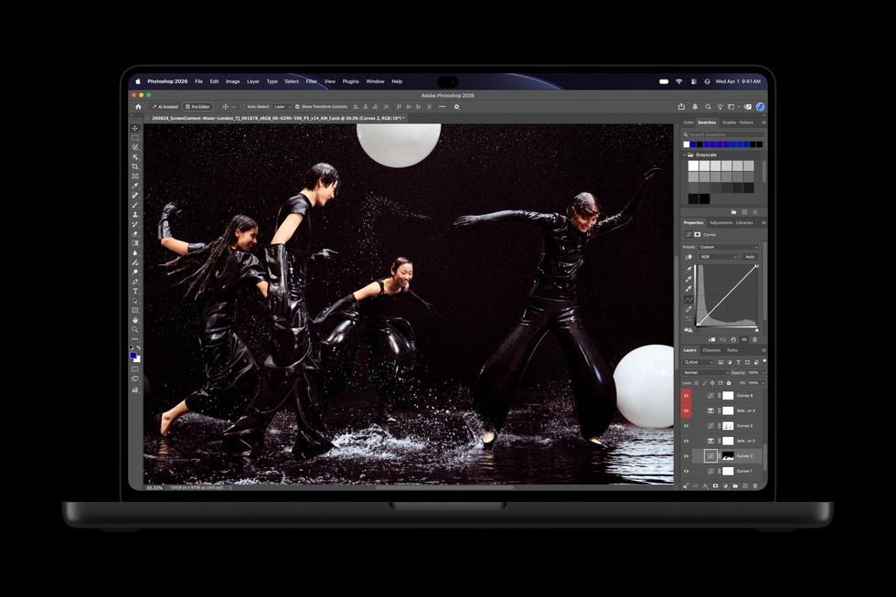 An open MacBook Pro with PROLED XDR Display shows the Photoshop app.