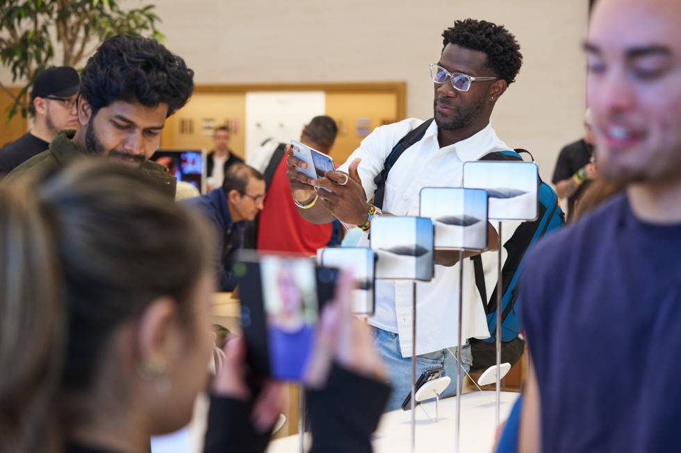 Customers and team members near the iPhone Duo display at Apple Domain NORTHSIDE.