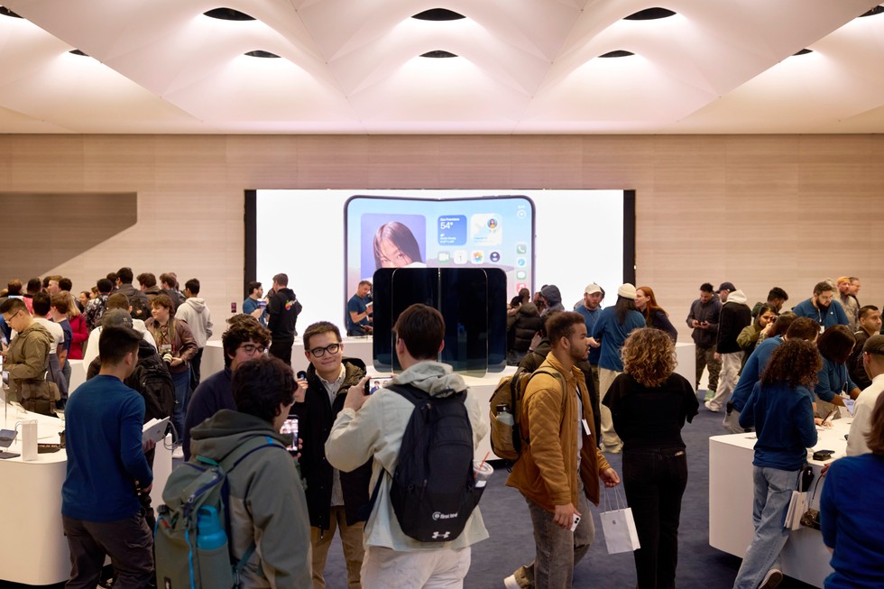 Apple Fifth Avenue bustles with team members helping customers explore iPhone Duo.