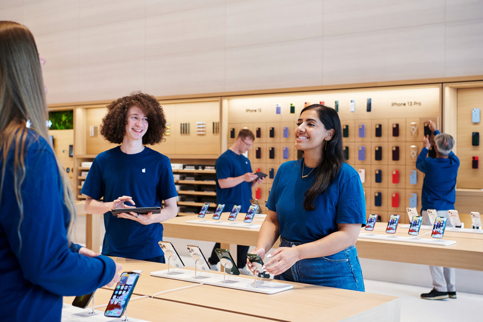 Three team members are shown inside Apple Brompton Road in London.