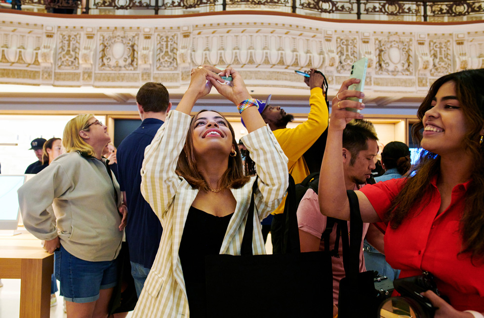 Customers take photographs of Apple Tower Theatre using iPhone.