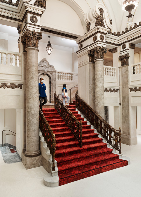 The lobby and red-carpeted staircase of Apple Tower Theatre.