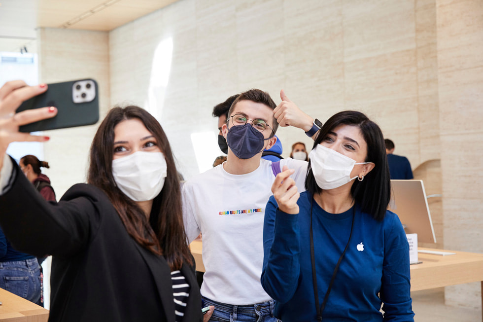 Customers and team members pose for a selfie.