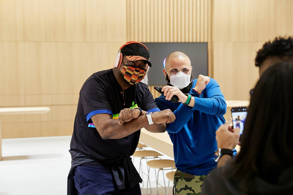 A customer and a team member inside Apple Bay Plaza getting their photo taken with an iPhone doing a Bronx pose.