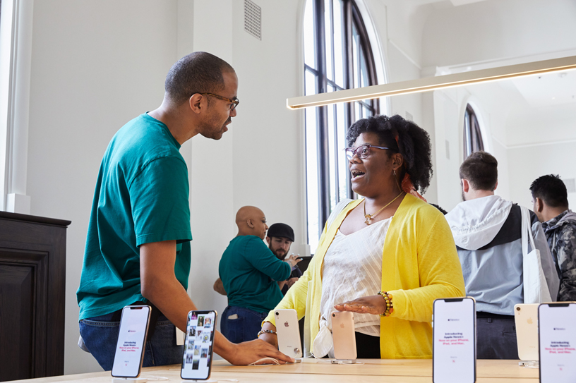 Apple Carnegie Library team member with customer.