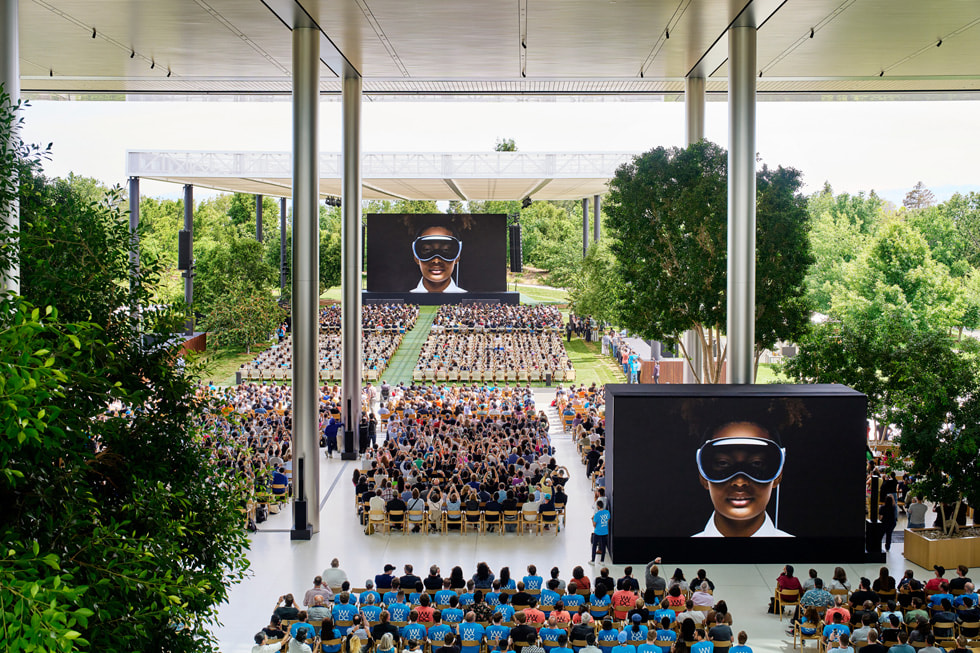 Hundreds of developers sit in chairs at Apple Park watching the WWDC23 keynote.
