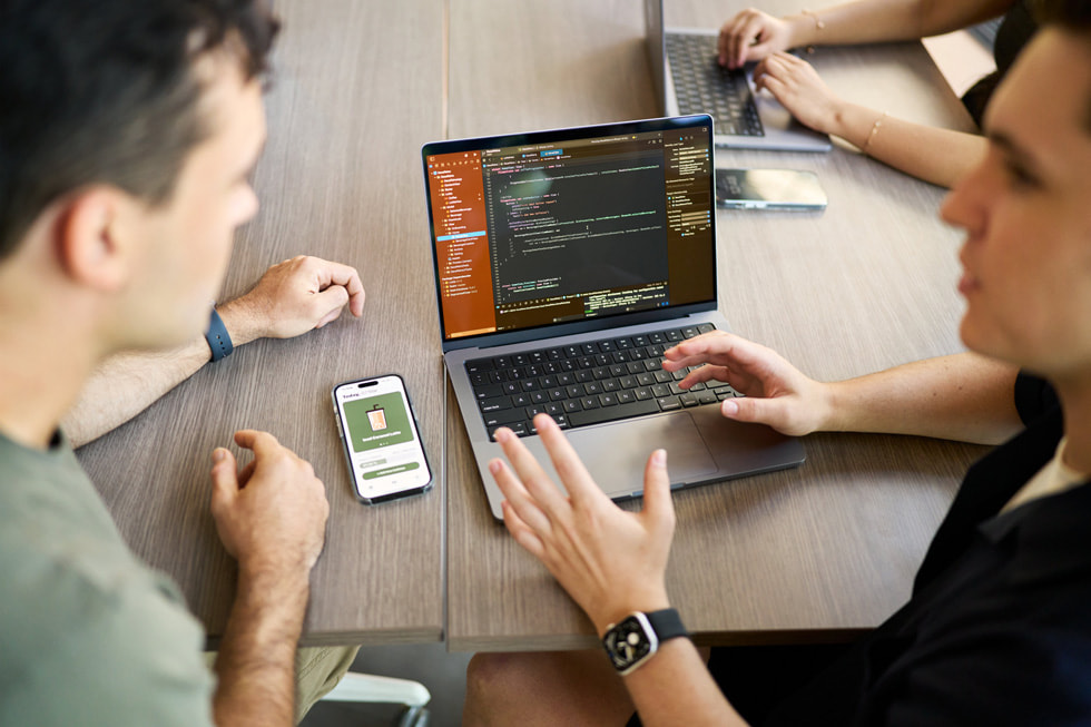 A group of students working on the Decaf app on MacBook.