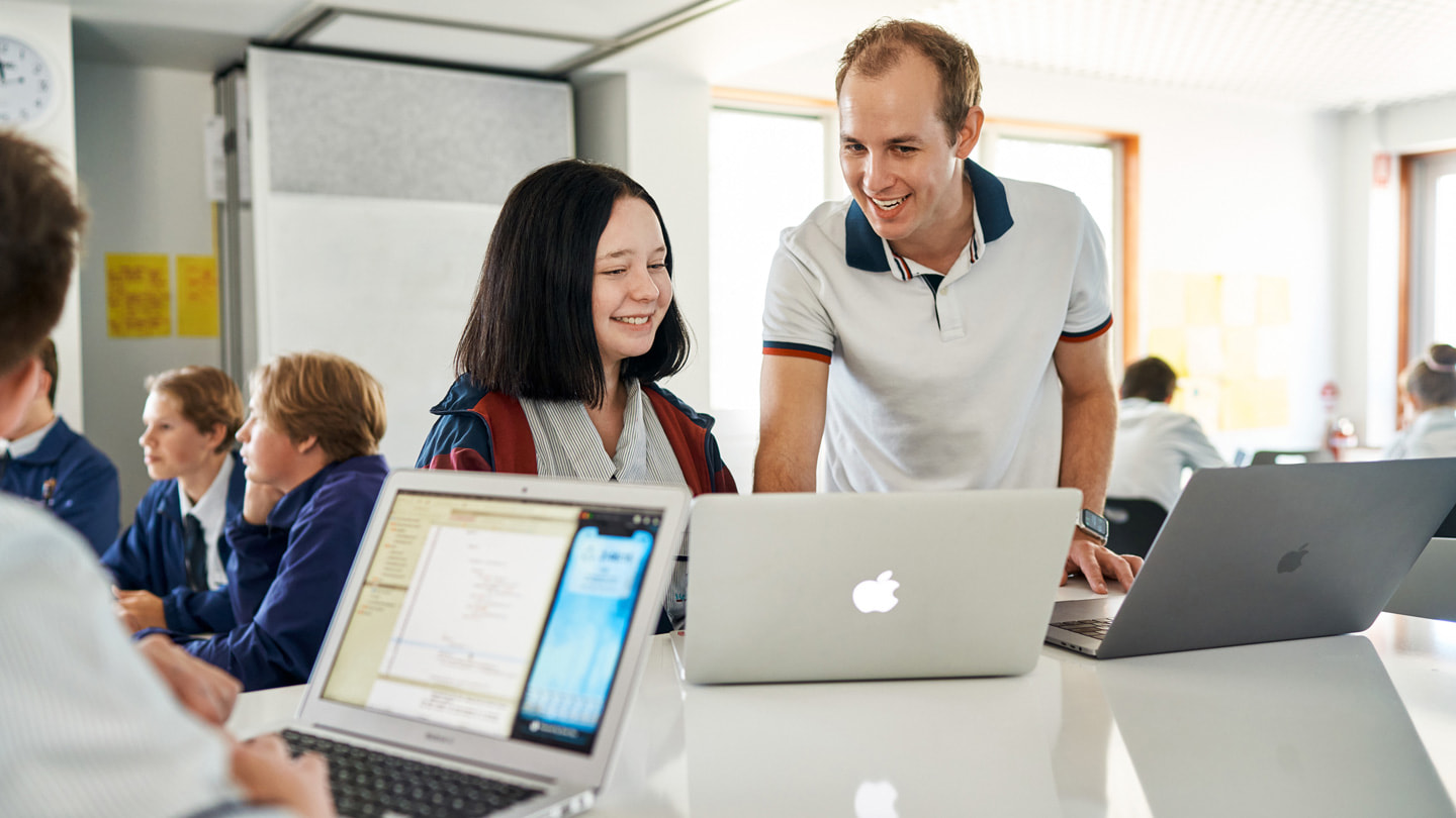 Oliver Baumeister teaches Swift to students at St Augustine’s College using MacBook Pro and MacBook Air .