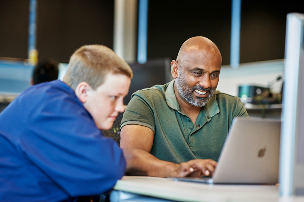 Daniel Parszuto and an instructor write code together on MacBook Air.