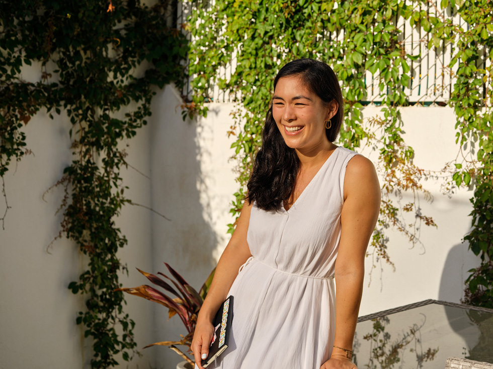 Hopscotch founder Samantha John stands in front of a wall.