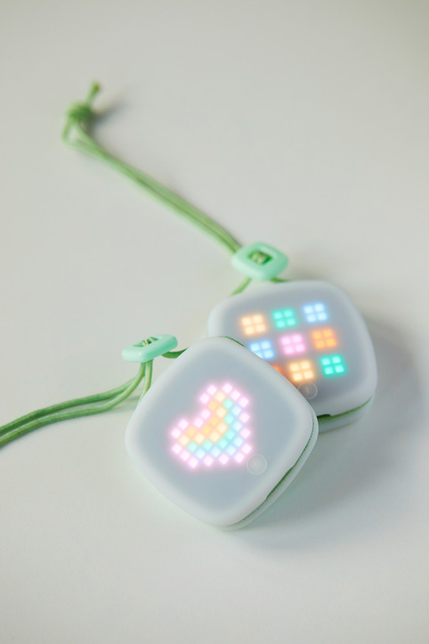 An imagiCharm featuring a pink, orange, and blue image of a heart created in the imagiLabs app.