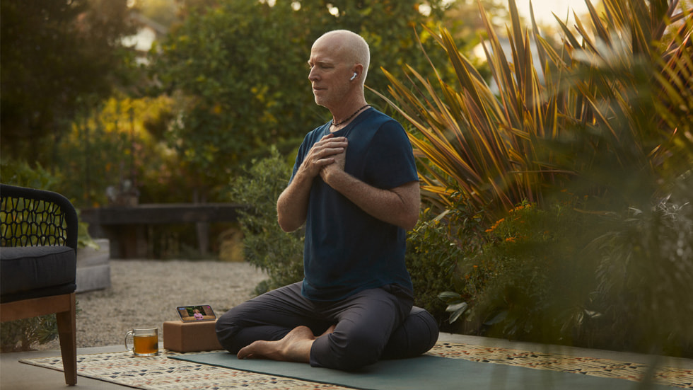 A person does yoga outdoors.