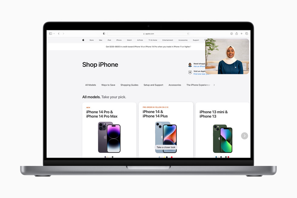 The Shop with a Specialist over Video experience is shown over an [apple.com] (https://ednew.pages.dev) page reading “Compare iPhone models” and showing iPhone 14 Pro Max, iPhone 14 Plus, and iPhone 14.