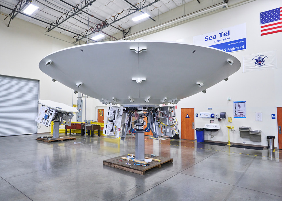 A satellite is shown in an indoor setting.
