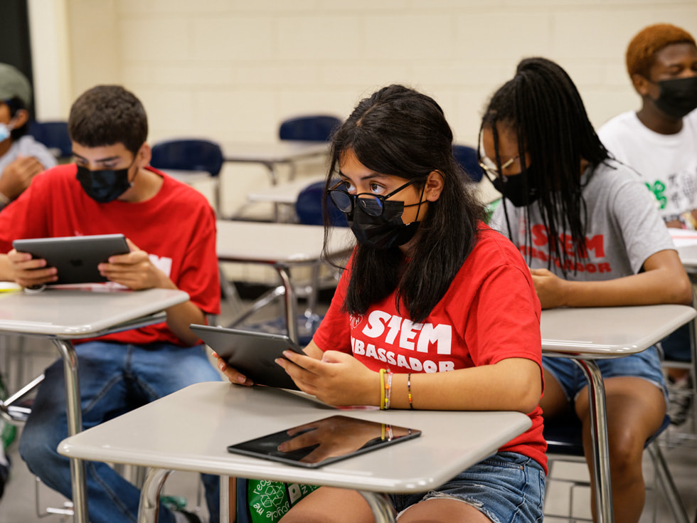 Students sit at desks and use iPad devices at the Rutgers 4-H Computers Pathways Program.