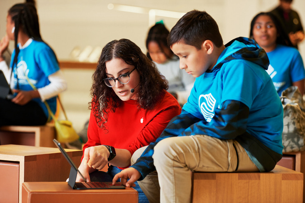 An Apple Creative pro guides a student through the Today at Apple session.