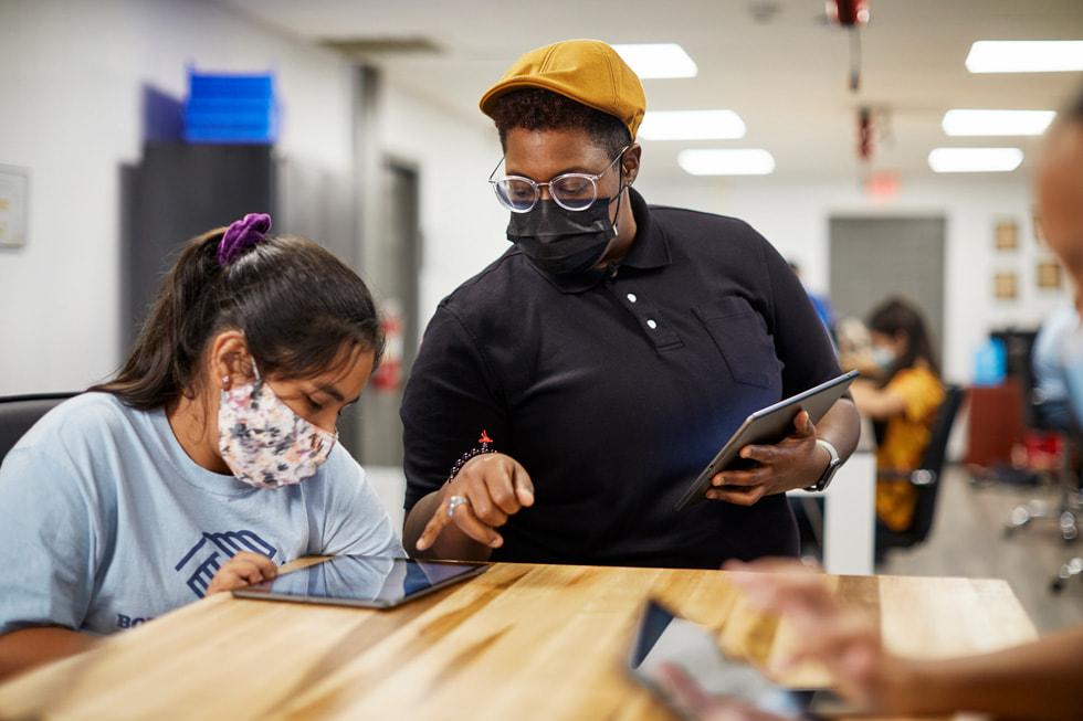 An instructor assists a student in a Boys & Girls Clubs of America classroom setting.