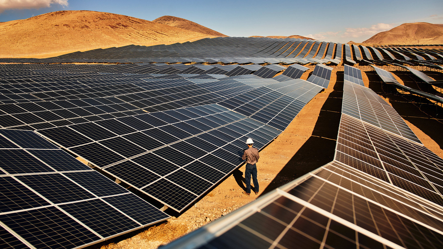 A technician inspects solar panels at the Turquoise solar farm in Nevada.