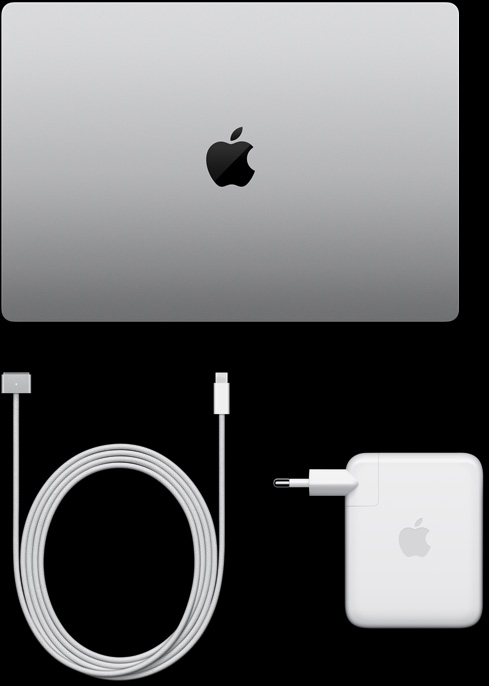 MacBook Pro, silver color, top, closed, next to charging cable and adapter