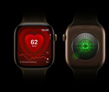 Two Apple Watch Series 12 devices side by side; Front-view of Apple Watch Series on left, screen displays heart rate monitor; Back-view of Apple Watch Series 12 on right, lights shine bright, colour green