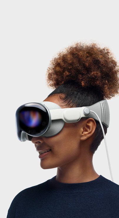 An employee smiles while wearing Apple Vision Pro and viewing content