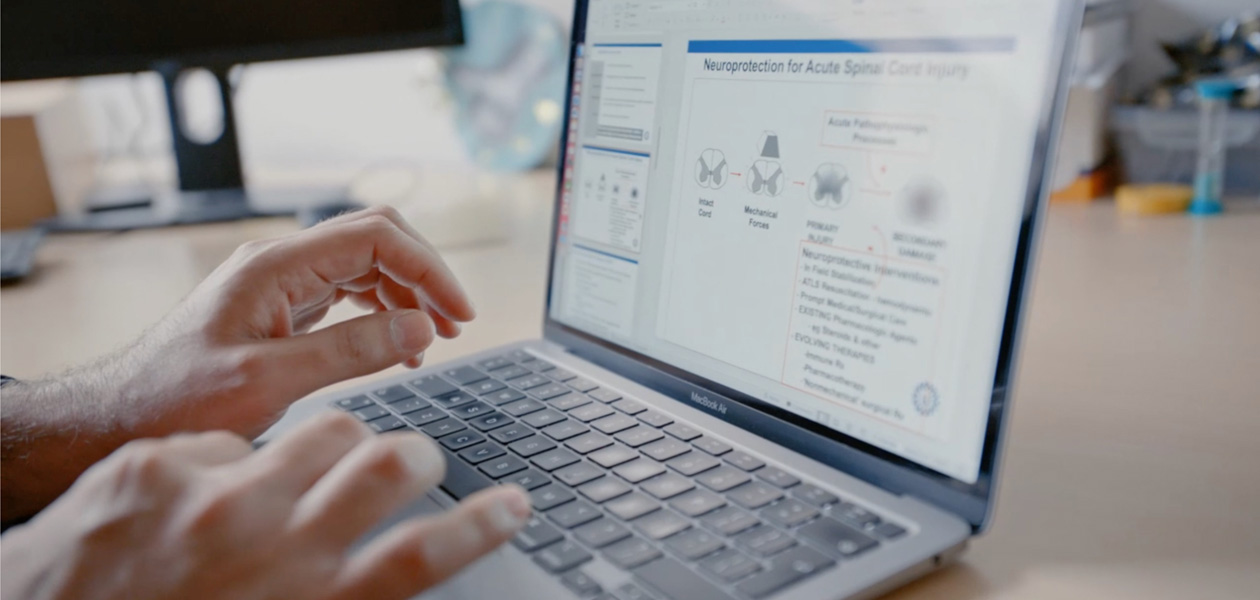 Hands typing on a MacBook Pro.