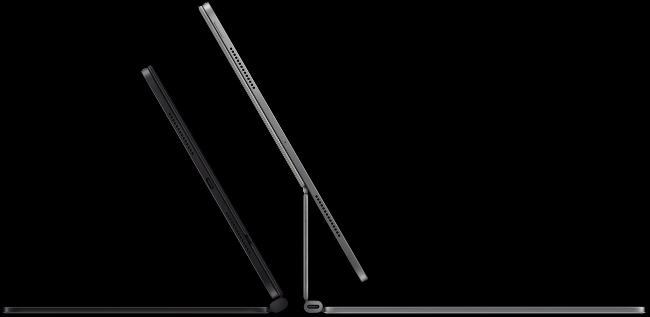 2 iPad Pro devices attached to Magic Keyboard, left: iPad Pro, side exterior, space black colour, microphones, attached to Magic Keyboard, side exterior, black colour, thin profile, iPad Pro tilted at 45-degree angle, right: iPad Pro, side exterior, silver colour, microphones, attached to Magic Keyboard, side exterior, silver colour, iPad Pro tilted at 45-degree angle showing the keyboard’s floating cantilever design and USB‑C connector