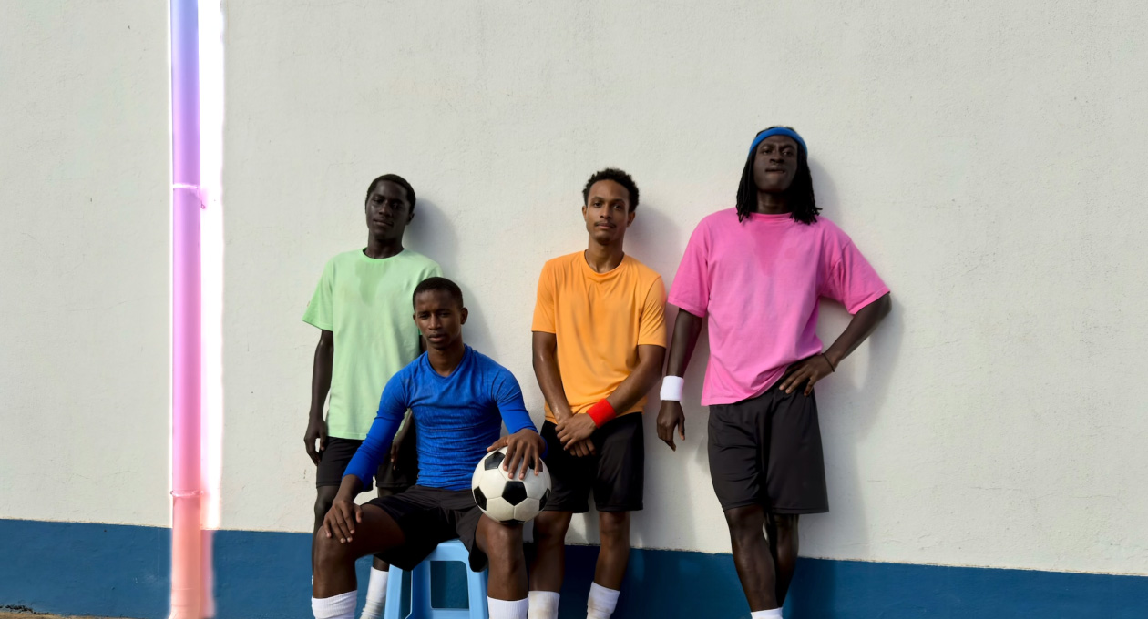 Using Clean Up tool to remove a drainpipe from a photo of football players posed against a wall